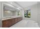 Elegant bathroom boasts double vanity, free-standing tub, and large mirror at 11323 Rivers Bluff Cir, Lakewood Ranch, FL 34202