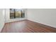 Bright bedroom with wood-look floors and large window at 11323 Rivers Bluff Cir, Lakewood Ranch, FL 34202