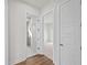 Bright hallway with hardwood floors and access to bedrooms and bathroom at 11323 Rivers Bluff Cir, Lakewood Ranch, FL 34202