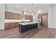 Modern kitchen with island, stainless steel appliances, and wood cabinets at 11323 Rivers Bluff Cir, Lakewood Ranch, FL 34202