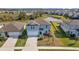 Two-story house, blue exterior, solar panels, landscaped yard, pond view at 11628 Middle Fork Way, Parrish, FL 34219