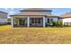 Spacious backyard with grassy area and screened porch at 11628 Middle Fork Way, Parrish, FL 34219