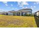 Spacious backyard with grassy area and screened porch at 11628 Middle Fork Way, Parrish, FL 34219