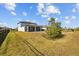 Large backyard with grassy area and screened patio at 11628 Middle Fork Way, Parrish, FL 34219