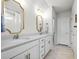 Double vanity bathroom with white cabinets and gold accents at 11628 Middle Fork Way, Parrish, FL 34219