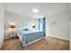 Bright bedroom with king-size bed and ensuite bathroom at 11628 Middle Fork Way, Parrish, FL 34219
