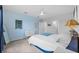 Light and airy bedroom with a queen-sized bed and blue walls at 11628 Middle Fork Way, Parrish, FL 34219