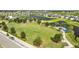 Aerial view of a community park with open field and playground at 11628 Middle Fork Way, Parrish, FL 34219