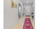 Light and airy entryway with tile floors and runner rug at 11628 Middle Fork Way, Parrish, FL 34219