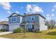 Two-story house with gray siding, attached garage, and landscaping at 11628 Middle Fork Way, Parrish, FL 34219