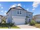 Two-story house with gray siding, attached garage, and landscaping at 11628 Middle Fork Way, Parrish, FL 34219