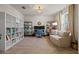 Home office with built-in shelving, desk, and comfortable seating at 11628 Middle Fork Way, Parrish, FL 34219