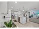 Open concept kitchen features white cabinets, stainless steel appliances, and island at 11628 Middle Fork Way, Parrish, FL 34219