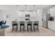 Modern kitchen with white cabinets, island with seating, and stainless steel appliances at 11628 Middle Fork Way, Parrish, FL 34219