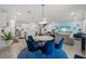 Open concept kitchen and dining area with modern appliances and blue chairs at 11628 Middle Fork Way, Parrish, FL 34219