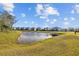 Community pond with lush landscaping and scenic views at 11628 Middle Fork Way, Parrish, FL 34219