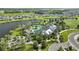 Aerial view of community pool, clubhouse, and surrounding landscape at 11628 Middle Fork Way, Parrish, FL 34219