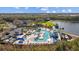 Aerial view of resort-style pool, expansive deck, and clubhouse at 11628 Middle Fork Way, Parrish, FL 34219