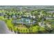 Aerial view of community pool, clubhouse, and surrounding landscape at 11628 Middle Fork Way, Parrish, FL 34219
