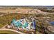 Community pool with a waterslide and plenty of lounge chairs at 11628 Middle Fork Way, Parrish, FL 34219