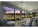 Relaxing screened porch overlooking a pond at sunset at 11628 Middle Fork Way, Parrish, FL 34219