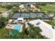 Aerial view of community amenities including tennis courts, pool, and clubhouse at 1214 Berkshire Cir, Venice, FL 34292