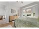 Bright bedroom with bay window, dresser, and light flooring at 1214 Berkshire Cir, Venice, FL 34292