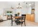 Bright dining room with a table, chandelier, and view to living room at 1214 Berkshire Cir, Venice, FL 34292