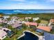 Aerial view showcasing a home with a pool and canal views at 12334 Baypointe Ter, Cortez, FL 34215