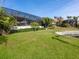 Large backyard with screened patio and lush landscaping at 12334 Baypointe Ter, Cortez, FL 34215