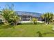 Spacious backyard with screened enclosure and tropical plants at 12334 Baypointe Ter, Cortez, FL 34215