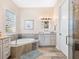 Spa-like bathroom with a soaking tub, tiled shower, and modern vanity at 12334 Baypointe Ter, Cortez, FL 34215
