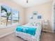 Guest bedroom with coastal decor and natural light at 12334 Baypointe Ter, Cortez, FL 34215