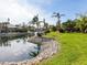Landscaped canal front lot with lush tropical foliage at 12334 Baypointe Ter, Cortez, FL 34215