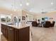 Open kitchen with island, granite counters, and view into living room at 12334 Baypointe Ter, Cortez, FL 34215