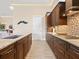 Modern kitchen with granite countertops, custom cabinetry, and a gas cooktop at 12334 Baypointe Ter, Cortez, FL 34215