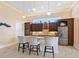 Kitchen with dark wood cabinets, granite counters, and stainless steel appliances at 12334 Baypointe Ter, Cortez, FL 34215