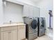Laundry room with washer, dryer, and ample storage at 12334 Baypointe Ter, Cortez, FL 34215