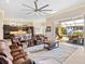 Living room with open kitchen and pool access at 12334 Baypointe Ter, Cortez, FL 34215