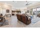 Open living space with leather recliners and a view of the kitchen at 12334 Baypointe Ter, Cortez, FL 34215