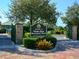 Entrance to Palma Sola Botanical Park, featuring a brick path and lush landscaping at 12334 Baypointe Ter, Cortez, FL 34215