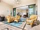 Relaxing patio with wicker furniture and view of the living room at 12334 Baypointe Ter, Cortez, FL 34215