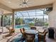 Covered patio with pool, table and chairs, and grill at 12334 Baypointe Ter, Cortez, FL 34215
