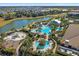Expansive aerial shot of a resort-style pool area with water features, lounge chairs, and lush landscaping at 12410 Osorio Ct # 101, Sarasota, FL 34238