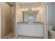 Bathroom featuring a large mirror, granite double vanity, and a walk-in shower at 12410 Osorio Ct # 101, Sarasota, FL 34238