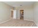 A bright bedroom with carpet, with an entrance to the ensuite bathroom at 12410 Osorio Ct # 101, Sarasota, FL 34238