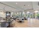 Elegant dining area featuring stylish tables, chairs, and ample natural light at 12410 Osorio Ct # 101, Sarasota, FL 34238