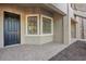 Close-up of a townhome entrance featuring a black door and a bay window at 12410 Osorio Ct # 101, Sarasota, FL 34238