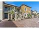 Inviting two-story townhomes with stylish staircases and well-maintained landscaping under a clear blue sky at 12410 Osorio Ct # 101, Sarasota, FL 34238