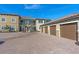 Townhome garages with a paved parking area, showcasing well-maintained exteriors at 12410 Osorio Ct # 101, Sarasota, FL 34238
